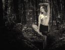 Fine Art nude photography in a forest using natural light, monochrome aesthetics and a timeless vintage-inspired composition.