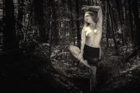 Fine Art nude photography in a forest using natural light, monochrome aesthetics and a timeless vintage-inspired composition.
